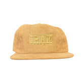 Brown cap with a logo on a dark wooden surface