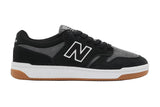 Black and gray sneaker with a white logo on a light gray background